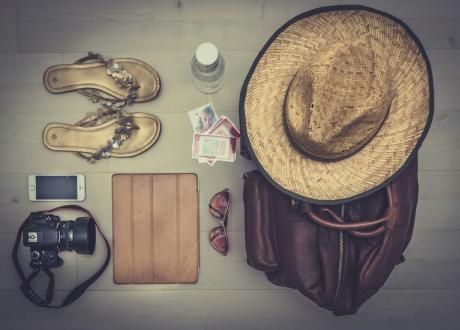 Objetos de viaje, mapa y accesorios preparados sobre una mesa